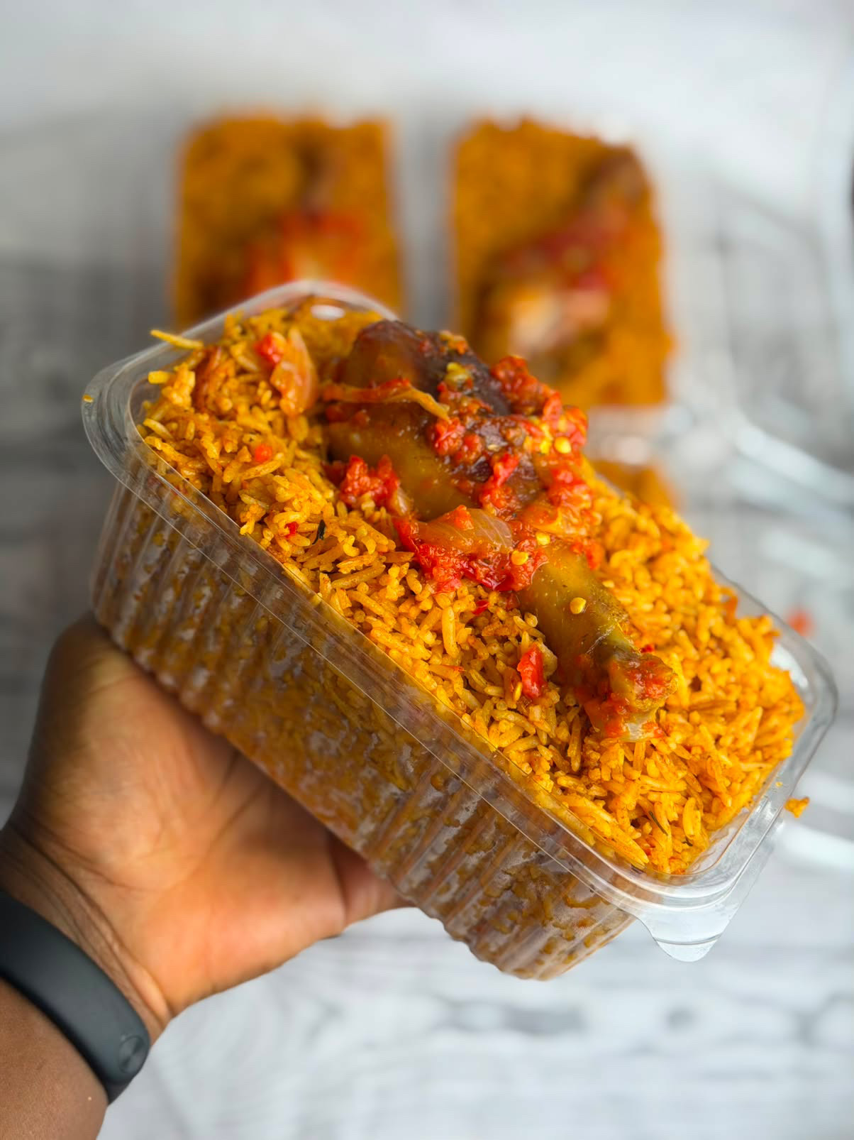 Signature jollof rice takeaway pack with chicken and pepper sauce