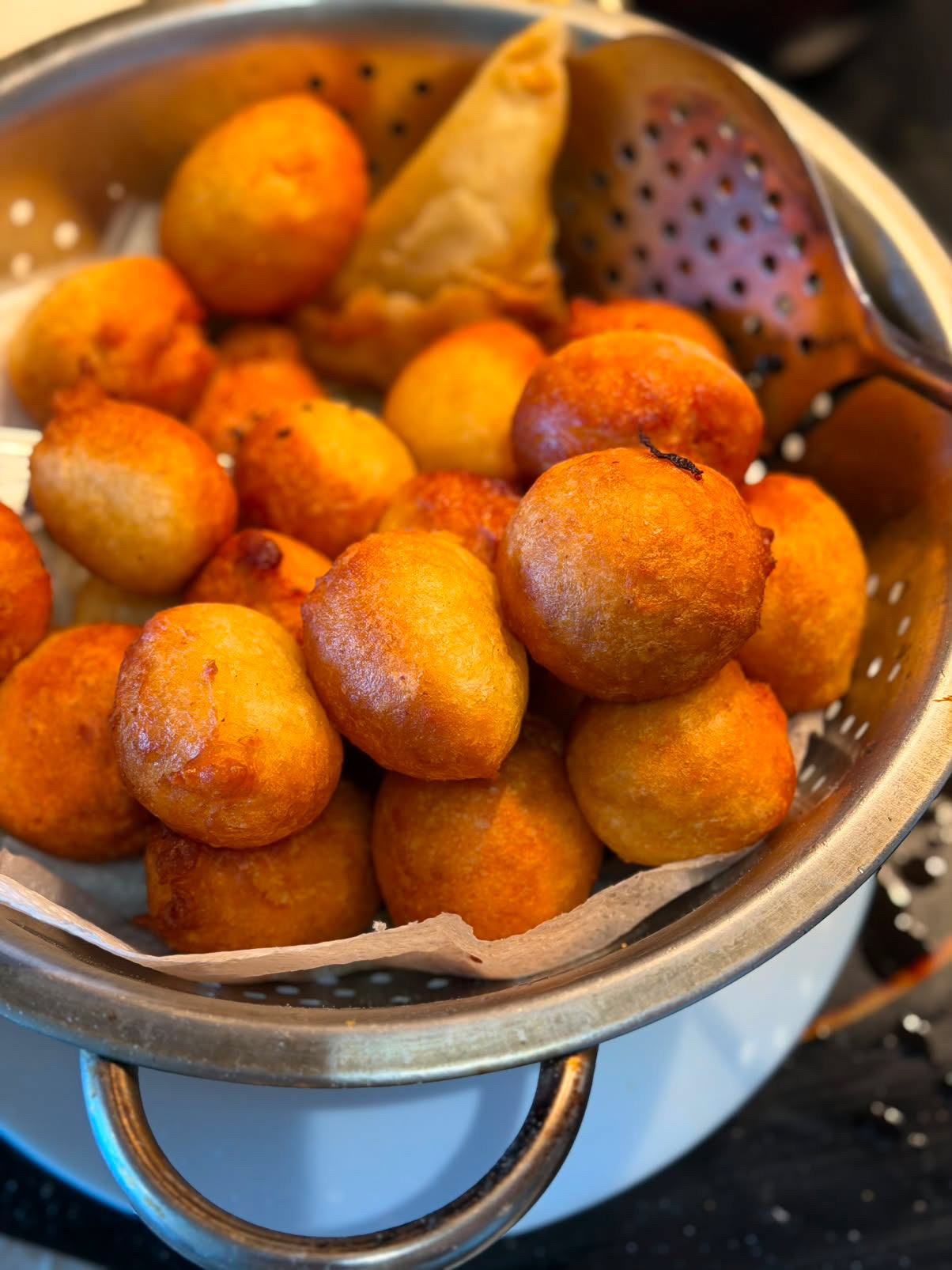 Basket of pillowy puff puff with samosa