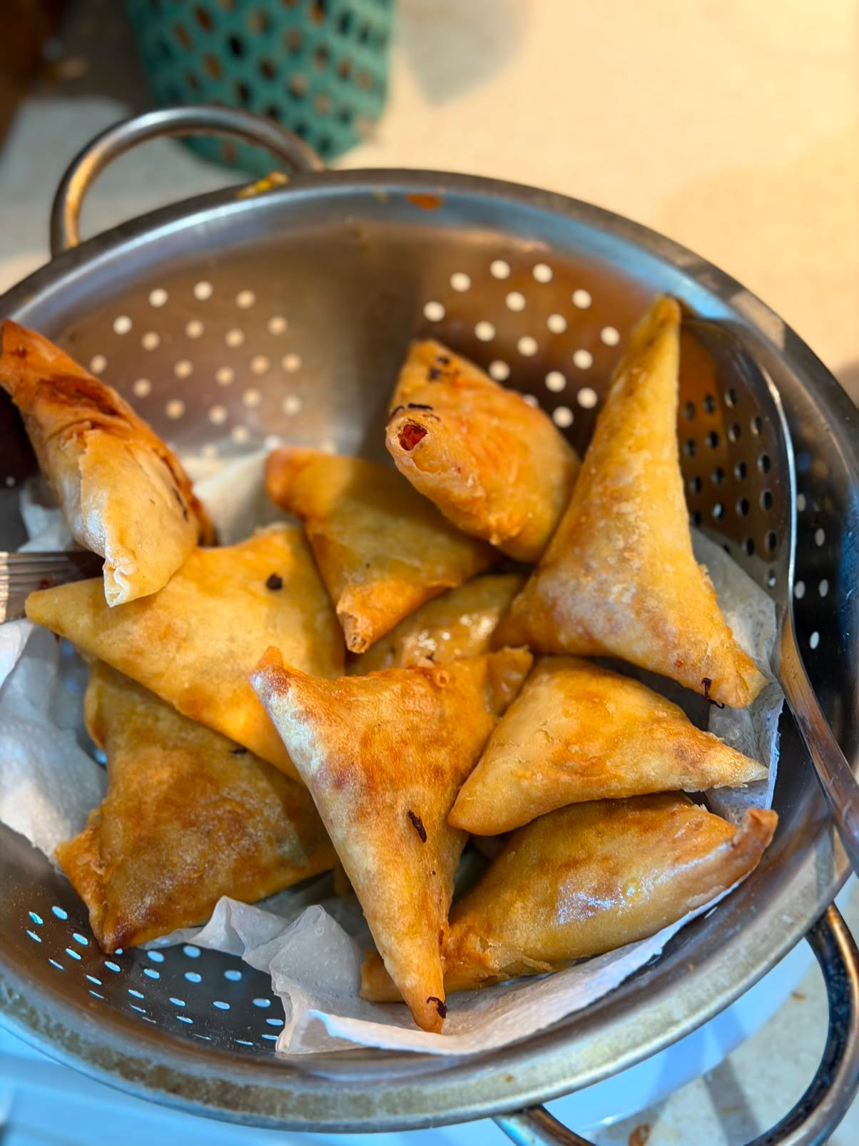 Hand-folded samosas, golden and flaky